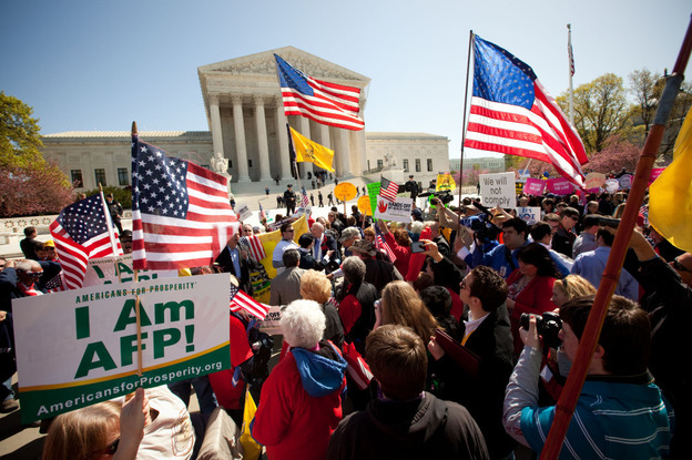 Demonstrators both for and against the new health care law turned out on the steps of the Supreme Court on Tuesday.