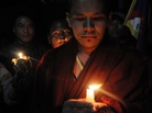 A Tibetan Buddhist monk holds up a candle with other Tibetan exiles during a candlelight vigil for Tibetan Janphel Yeshi, who set himself on fire earlier in New Delhi. A Tibetan Buddhist monk holds up a candle with other Tibetan exiles during a candlelight vigil for Tibetan Janphel Yeshi, who set himself on fire earlier in New Delhi.
