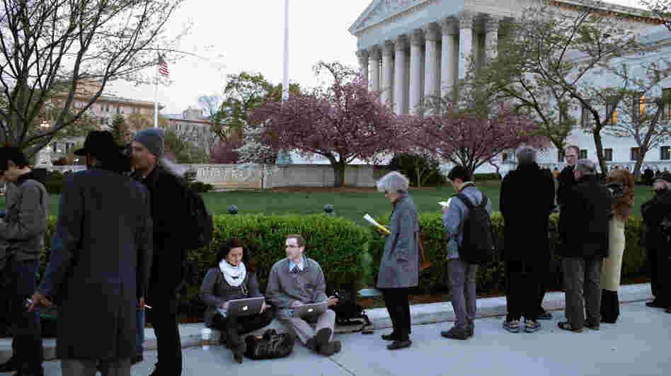 People wait for tickets to attend the last day of arguments over the Affordable Care Act at the Supreme Court. People wait for tickets to attend the last day of arguments over the Affordable Care Act at the Supreme Court.
