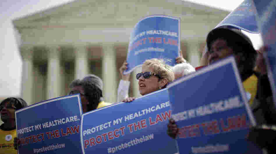 Supporters of the health care law rally in front of the Supreme Court Wednesday, the final day of arguments over its constitutionality.