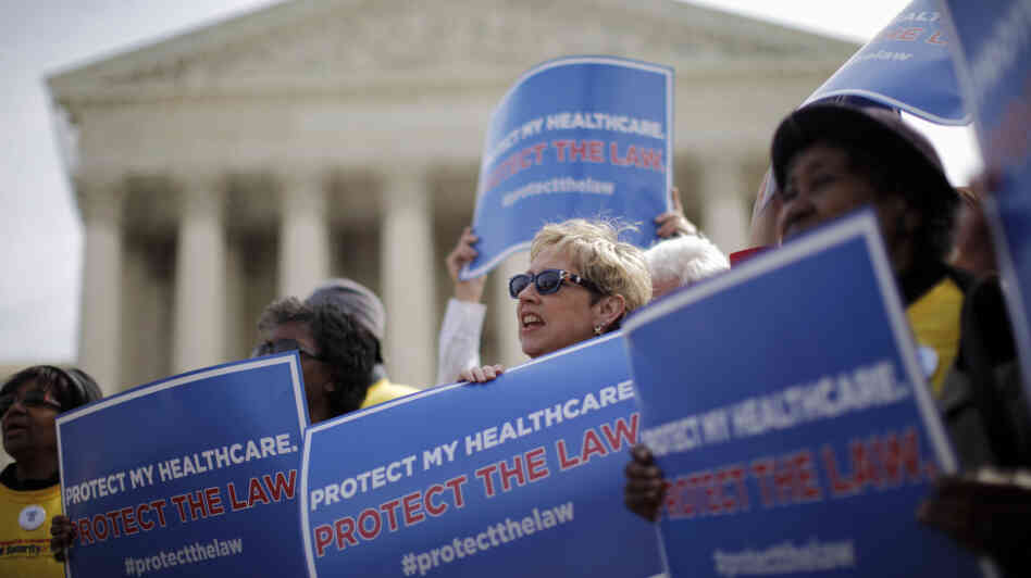 Supporters of the health care law rally in front of the Supreme Court Wednesday, the final day of arguments over its constitutionality.
