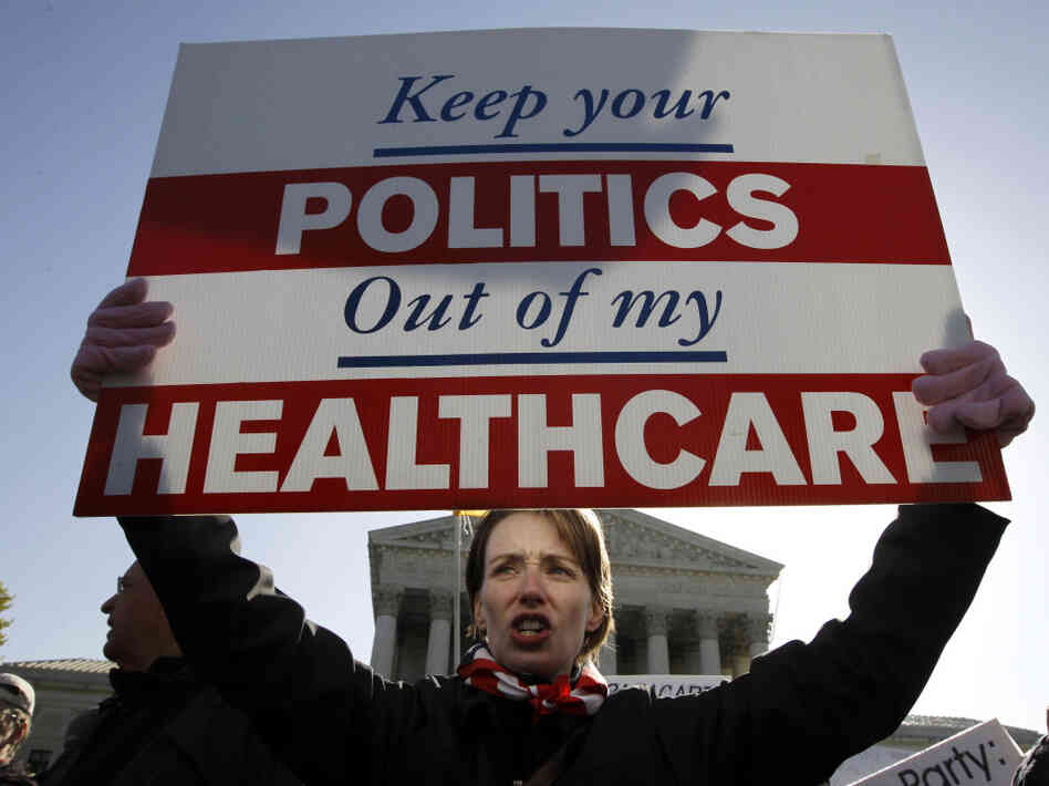 Amy Brighton from Medina, Ohio, who opposes the new health care law, rallies in front of the Supreme Court on Tuesday.