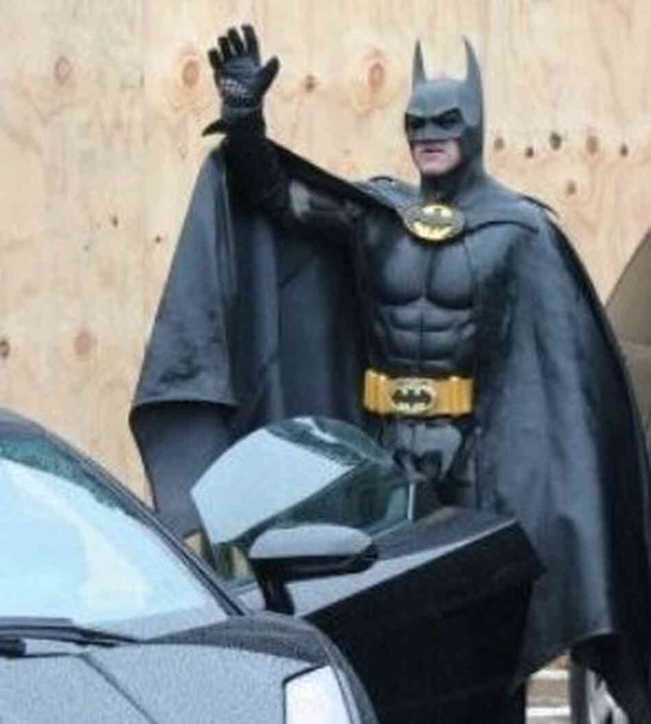 The Caped Crusader, about to get into his Batmobile.