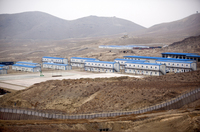 Hesco barriers and concertina wire surround the living quarters of the Chinese-owned Ainak copper mine in Logar, Afghanistan, in 2011.