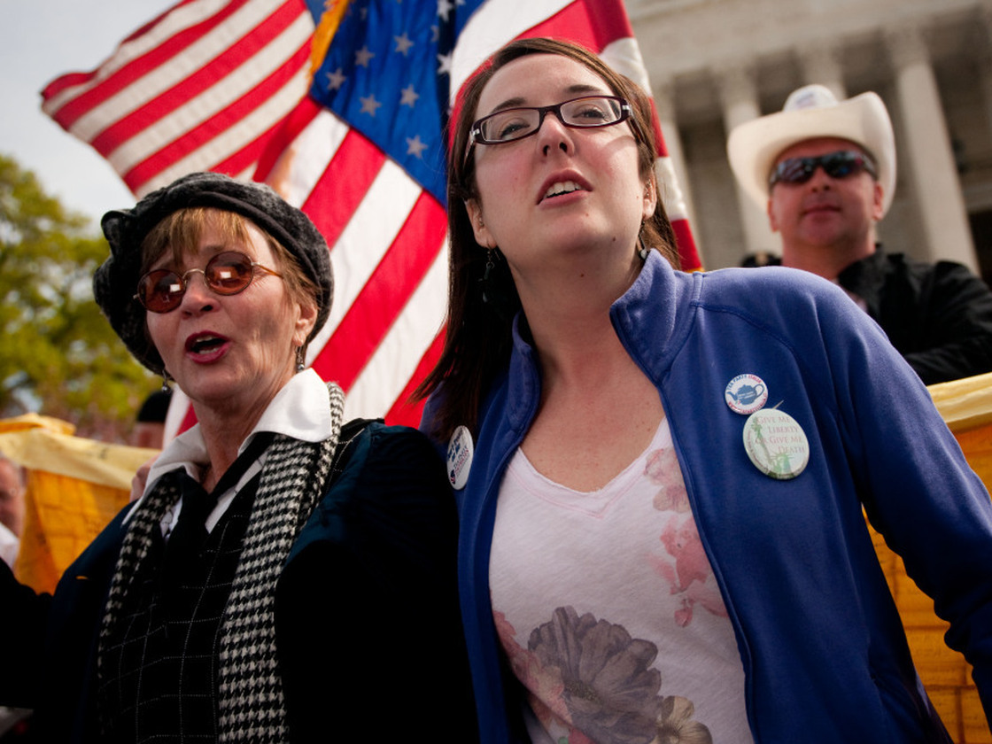 Linda Dorr (left) and Keli Carender chant along with other demonstrators in front of the Supreme Court on Wednesday.