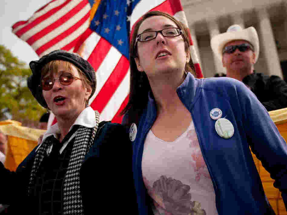 Linda Dorr (left) and Keli Carender chant along with other demonstrators in front of the Supreme Court on Wednesday.