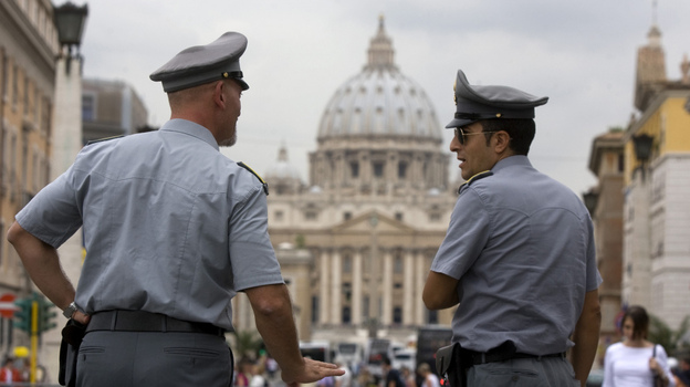 Italian financial police officers talk in front of St. Peter's Basilica in Rome. Recently leaked Vatican documents have raised questions about the Vatican's financial transactions. Italian financial police officers talk in front of St. Peter's Basilica in Rome. Recently leaked Vatican documents have raised questions about the Vatican's financial transactions.