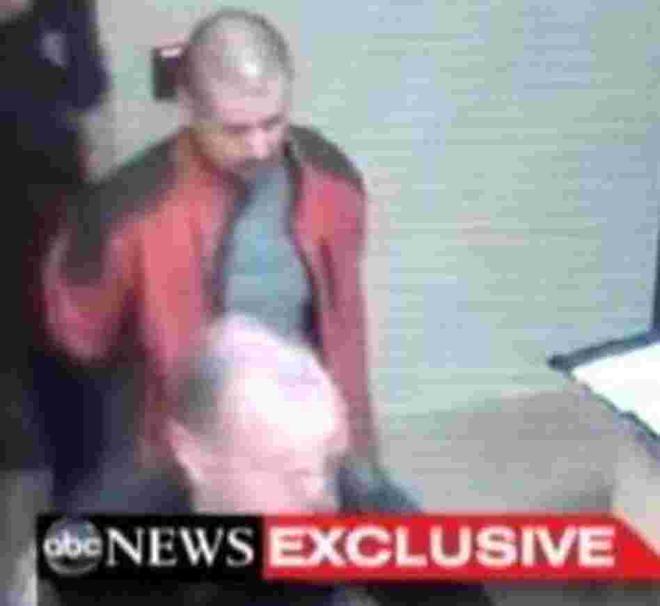 George Zimmerman, in the red jacket, as he was led through a police station in Sanford, Fla., after the Feb. 26 shooting death of Trayvon Martin.