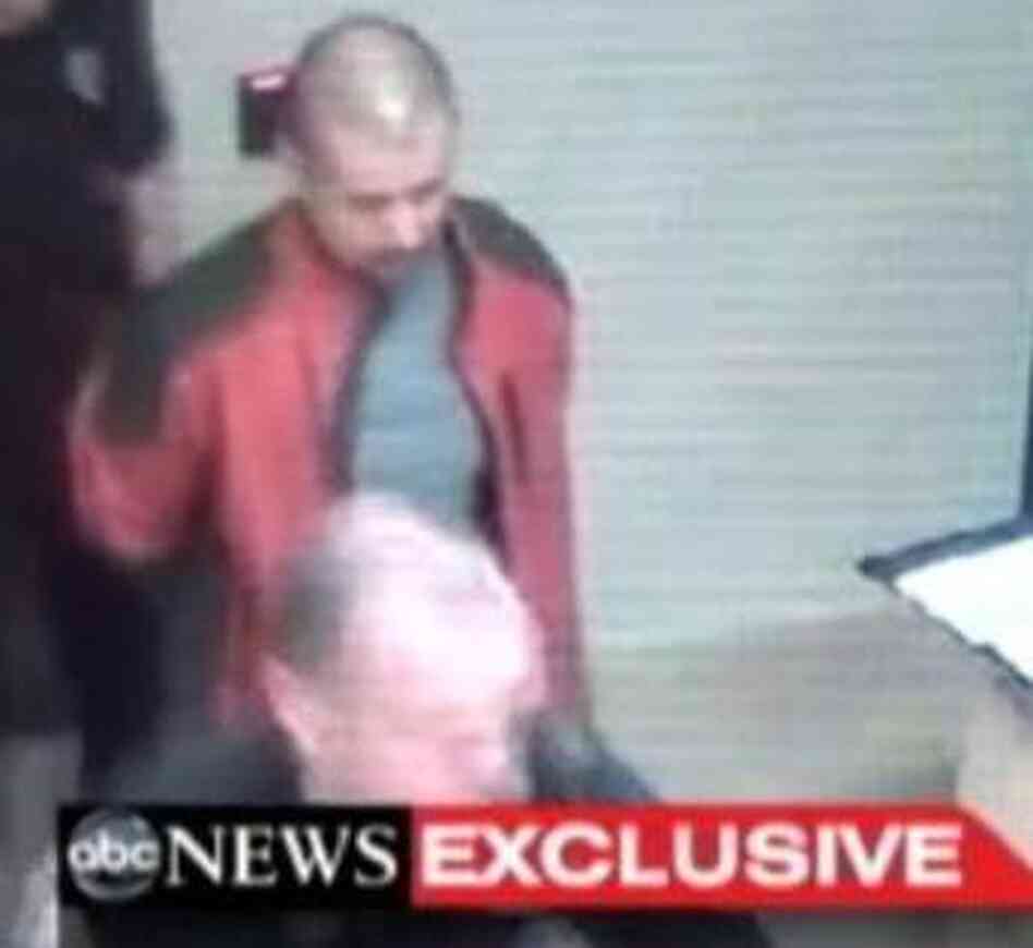 George Zimmerman, in the red jacket, as he was led through a police station in Sanford, Fla., after the Feb. 26 shooting death of Trayvon Martin.