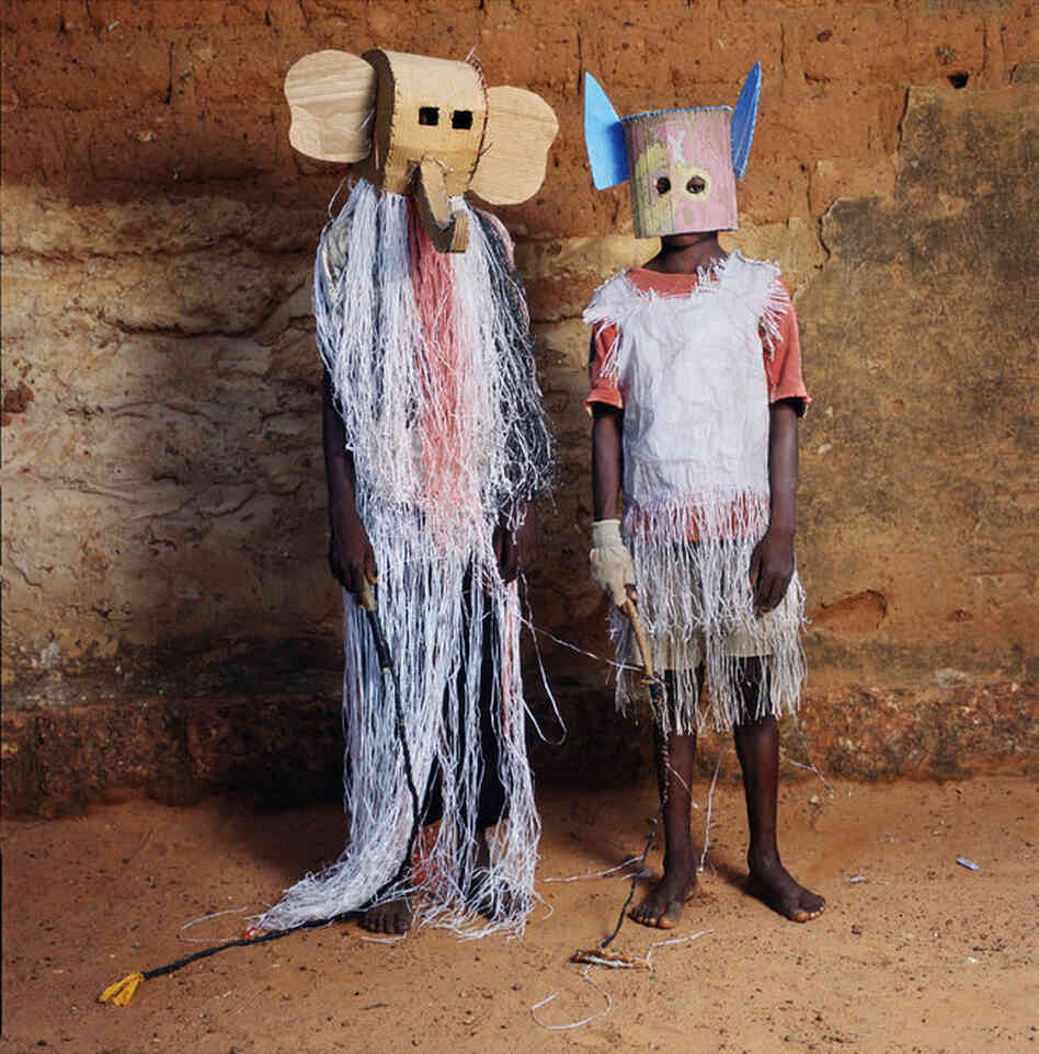 "An elephant and a bat pose at the Dodo Masquerade in Burkina Faso, an event where children don masks, sing and dance under a full moon."