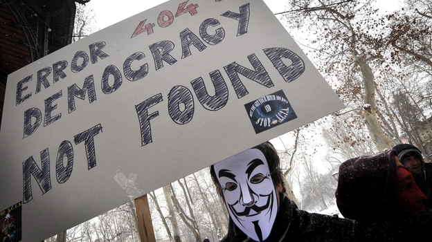 The group Anonymous has threatened to take down the Internet on Saturday to protest anti-piracy proposals that they consider online censorship. Here, a masked protester demonstrates against one such measure last month in Zagreb, Croatia, last month.