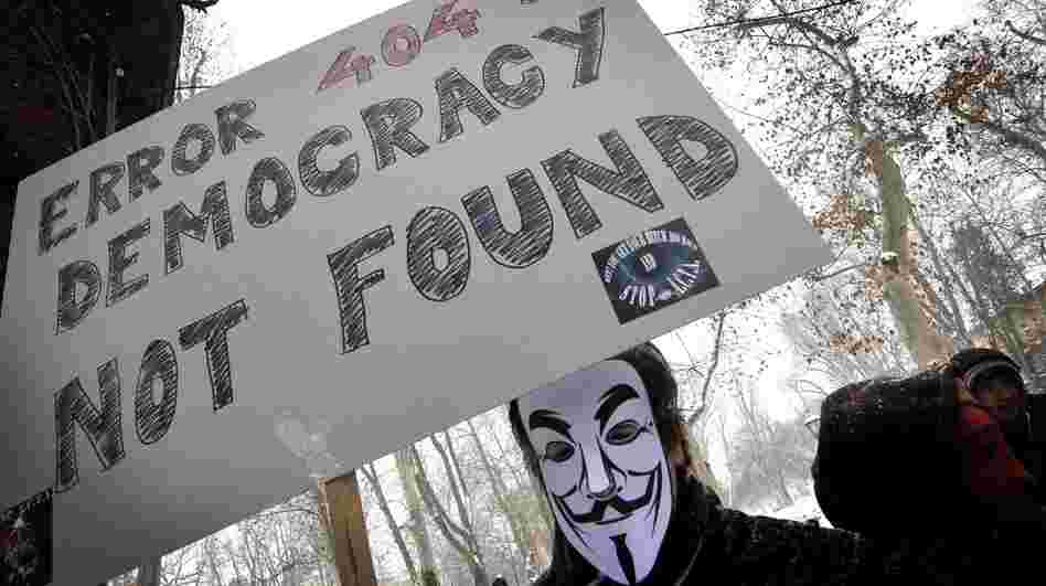 The group Anonymous has threatened to take down the Internet on Saturday to protest anti-piracy proposals that they consider online censorship. Here, a masked protester demonstrates against one such measure last month in Zagreb, Croatia, last month.