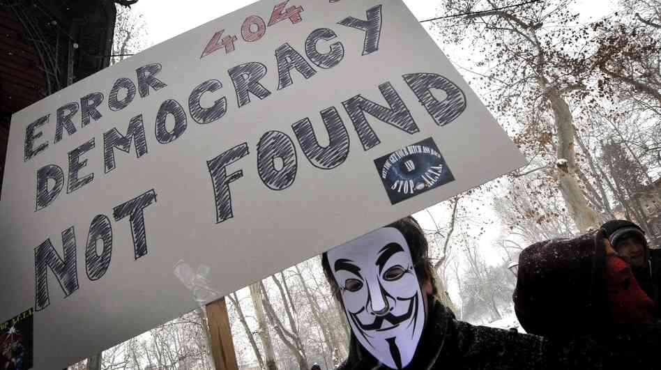 The group Anonymous has threatened to take down the Internet on Saturday to protest anti-piracy proposals that they consider online censorship. Here, a masked protester demonstrates against one such measure last month in Zagreb, Croatia, last month.