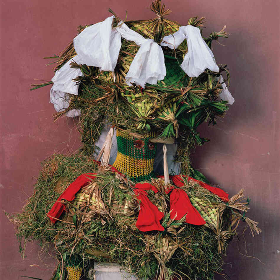"Other spirits represent nature of esteemed ancestors who guide, judge, or entertain the living. They're portrayed with forest greenery and netlike facribs ... during Christmastime in urban Calabar [Nigeria]."