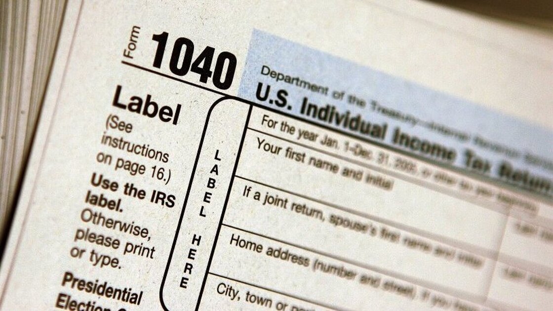 A pile of IRS Form 1040 tax documents is seen in this file photo. Personal finance experts recommend keeping most records for three years after they're used in a tax return.