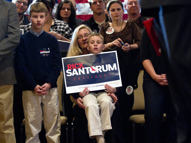 Supporters listen to Republican presidential candidate Rick Santorum at The Ravine in Bellevue, Wis., on March 24. Some voters in the state are complaining about a barrage of negative ads in advance of Tuesday's primary. 