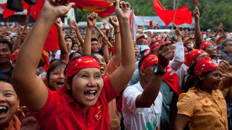  Supporters of the opposition National League for Democracy celebrate their victory in parliamentary elections outside the party headquarters in Yangon, Myanmar, on Sunday. The results could help to consolidate support for political reforms and herald the end of foreign sanctions on the country.