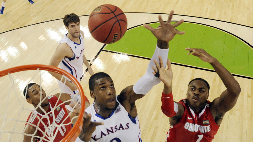 Kansas' Thomas Robinson (0) fights for a rebound with Ohio State's Deshaun Thomas (1) during the second half of an NCAA Final Four semifinal college basketball tournament game Saturday in New Orleans.