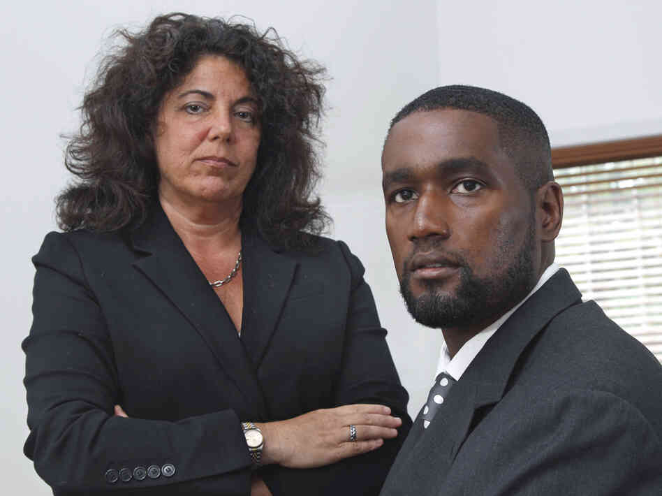 In this Oct. 11, 2011, photo, Albert Florence sits at his home in Bordentown, N.J., with his attorney, Susan Chana Lask. Florence sued after being strip-searched in 2005 when he was arrested because of a computer error.