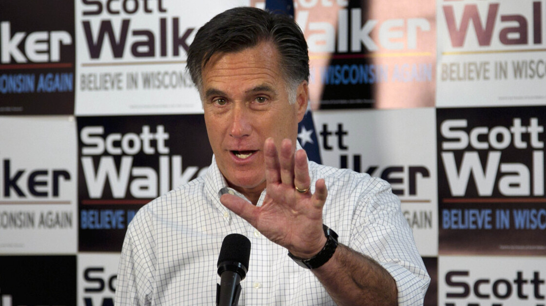 Mitt Romney has campaigned in the shadow of embattled Republican Gov. Scott Walker, who faces a recall vote in June. Here, Romney speaks with Walker supporters at a phone bank during a campaign stop in Fitchburg, Wis., on Saturday.