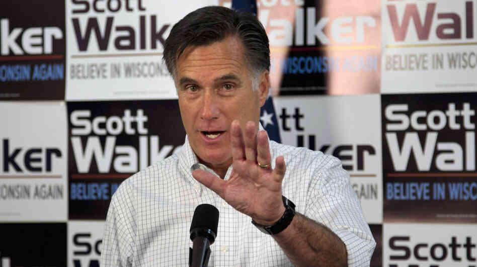 Mitt Romney has campaigned in the shadow of embattled Republican Gov. Scott Walker, who faces a recall vote in June. Here, Romney speaks with Walker supporters at a phone bank during a campaign stop in Fitchburg, Wis., on Saturday.