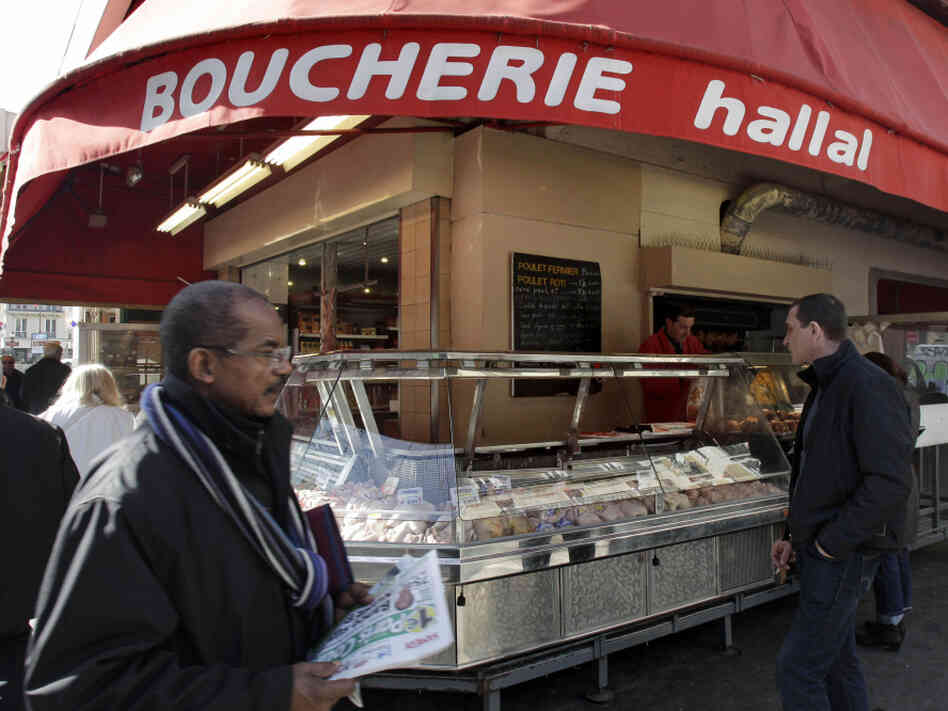 A butcher shop in Paris, which prominently advertises that it sells halal meat.