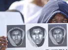At a rally in Miami on Sunday, Arleen Poitier held a sign with images of Trayvon Martin. At a rally in Miami on Sunday, Arleen Poitier held a sign with images of Trayvon Martin.