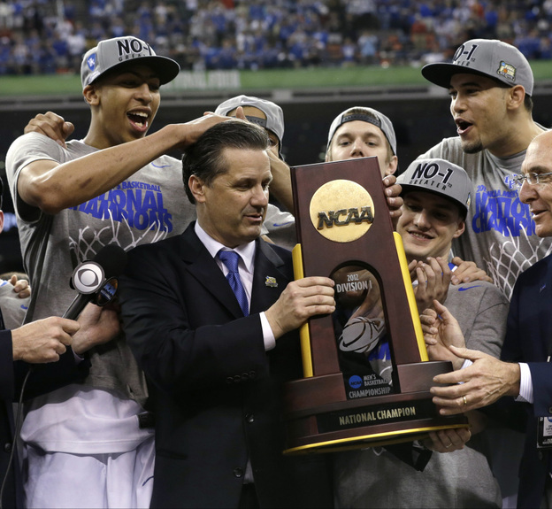 Kentucky head coach John Calipari (center) celebrates with his team after the Wildcats beat the University of Kansas on Monday to clinch the title.