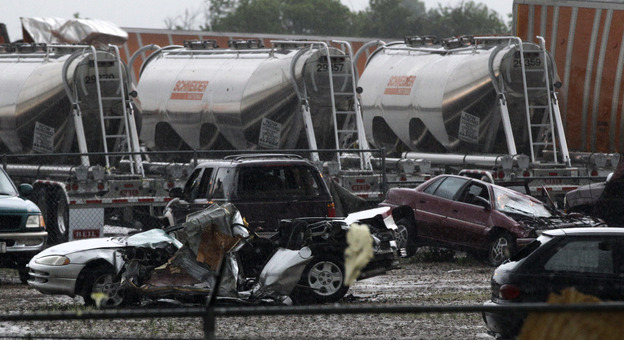 Destroyed vehicles sit in a Kenworth trailer lot after a tornado that swept through the area toppling many of the trailers on the lot on Tuesday in Lancaster, Texas. 