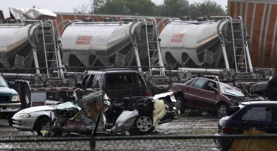 Destroyed vehicles sit in a Kenworth trailer lot after a tornado that swept through the area toppling many of the trailers on the lot on Tuesday in Lancaster, Texas. 