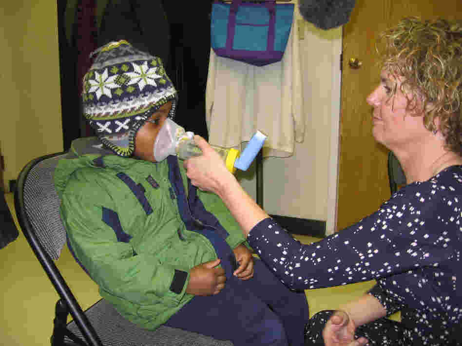 Kathy Harvey of the Zigler Head Start Center in New Haven, Conn., gives 4-year-old student Anthony Hebert an asthma treatment.