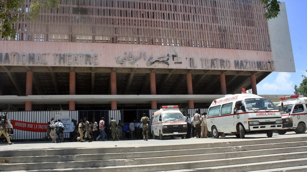 Ambulances are parked outside the Mogadishu National Theatre on Wednesday after a suicide attack in the Somali capital. A young woman strapped with explosives blew herself up on at a ceremony in the Somali national theater attended by the prime minister and other officials.