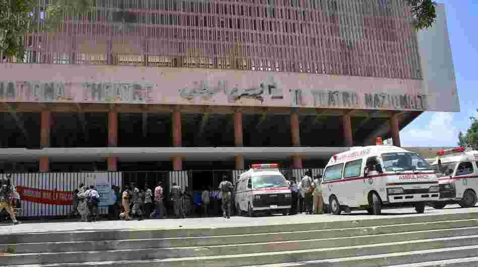 Ambulances are parked outside the Mogadishu National Theatre on Wednesday after a suicide attack in the Somali capital. A young woman strapped with explosives blew herself up on at a ceremony in the Somali national theater attended by the prime minister and other officials.