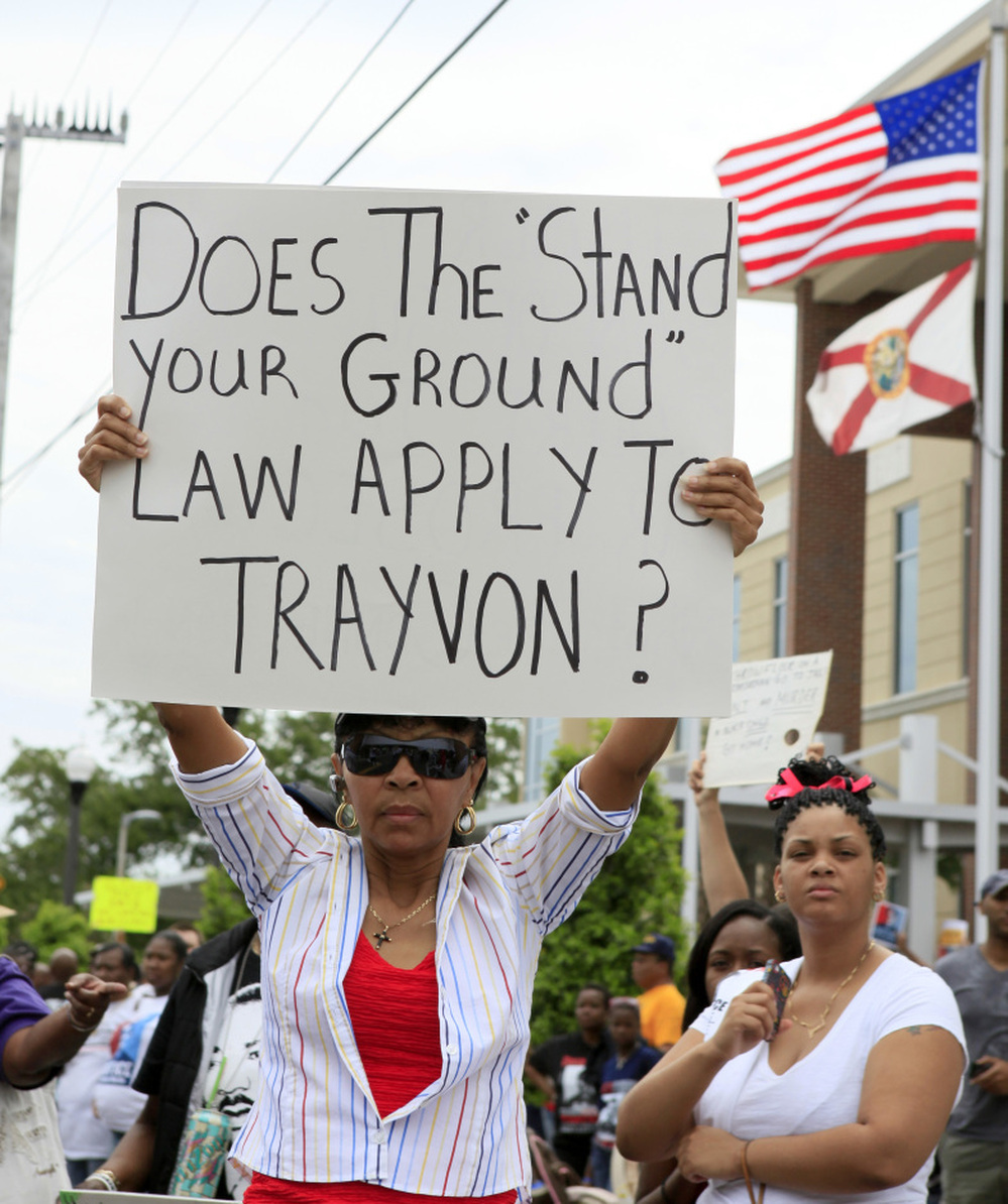 Selina Gray of Sanford, Fla., shows her sign at a rally protesting the death of Trayvon Martin, the unarmed teen shot by a neighborhood watch volunteer. Authorities have cited the state's "stand your ground" law as a reason charges have not been filed in Martin's death.