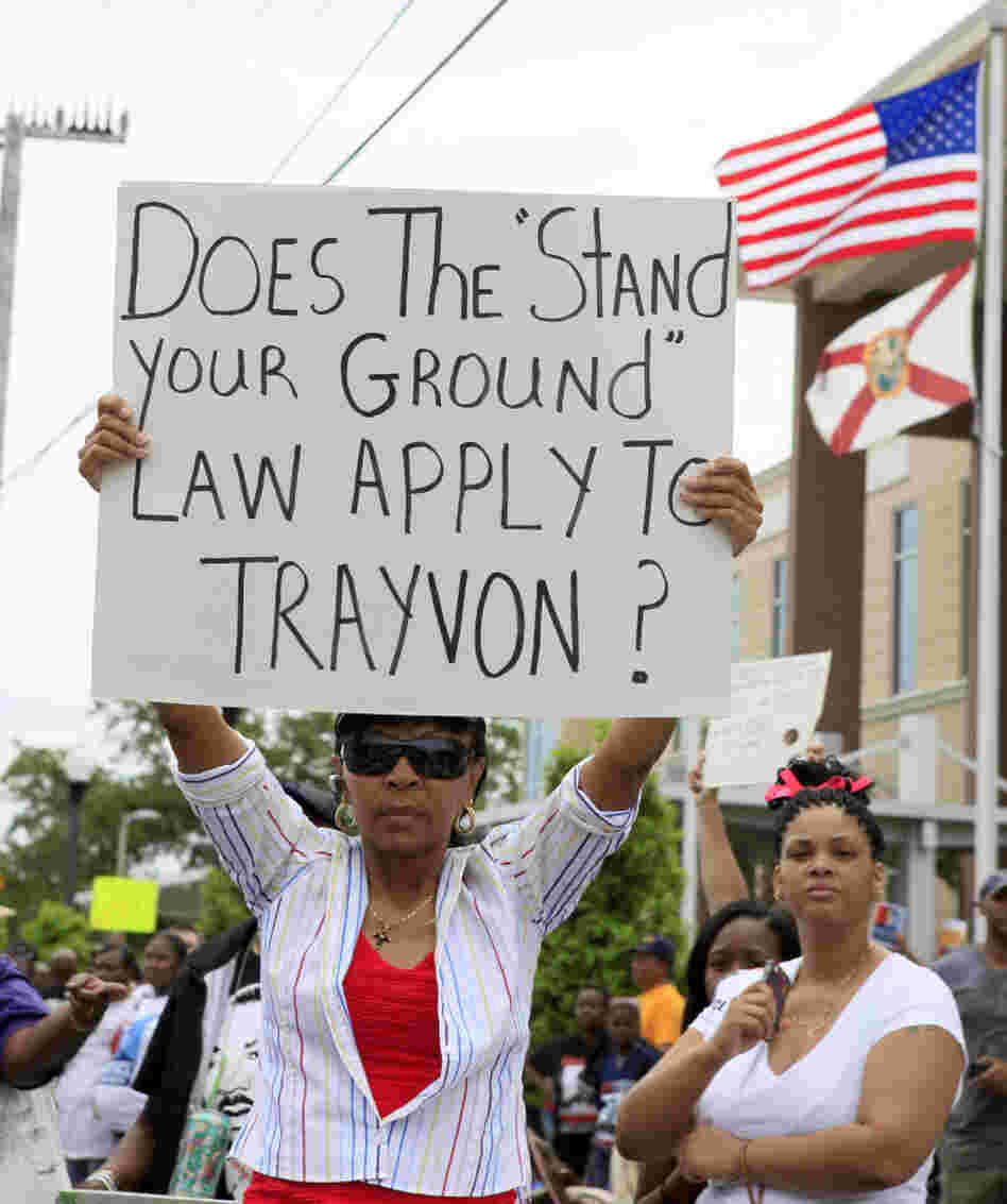 Selina Gray of Sanford, Fla., shows her sign at a rally protesting the death of Trayvon Martin, the unarmed teen shot by a neighborhood watch volunteer. Authorities have cited the state's "stand your ground" law as a reason charges have not been filed in Martin's death.