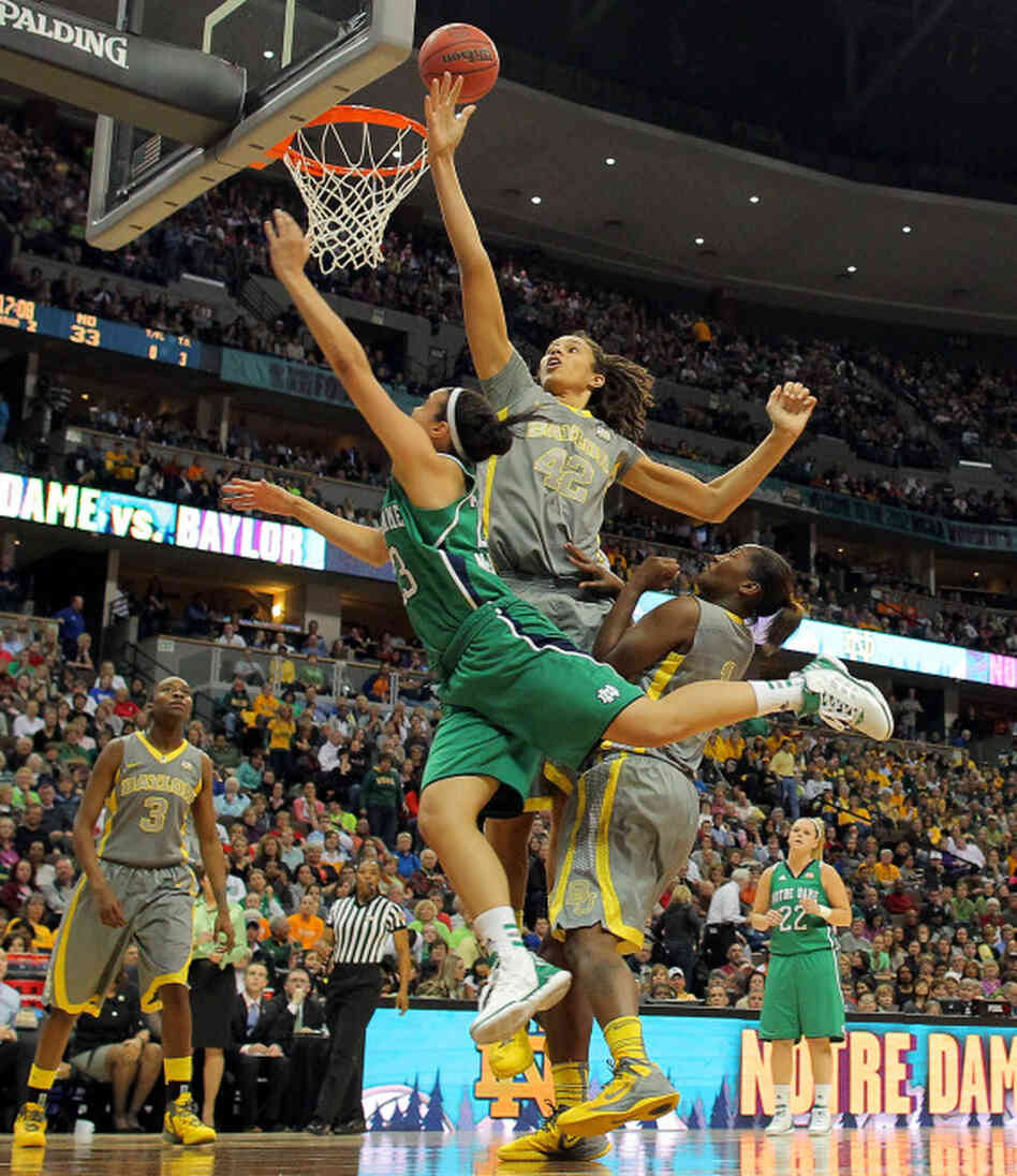Brittney Griner (#42) of the Baylor Lady Bears blocks a shot attempt by Kayla McBride (#23) of the Notre Dame Fighting Irish during Tuesday night's NCAA Division I women's basketball championship game in Denver. 