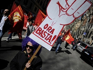 Members of the Italian metalworkers trade union Fiom-CGIL hold a placard reading Members of the Italian metalworkers trade union Fiom-CGIL hold a placard reading