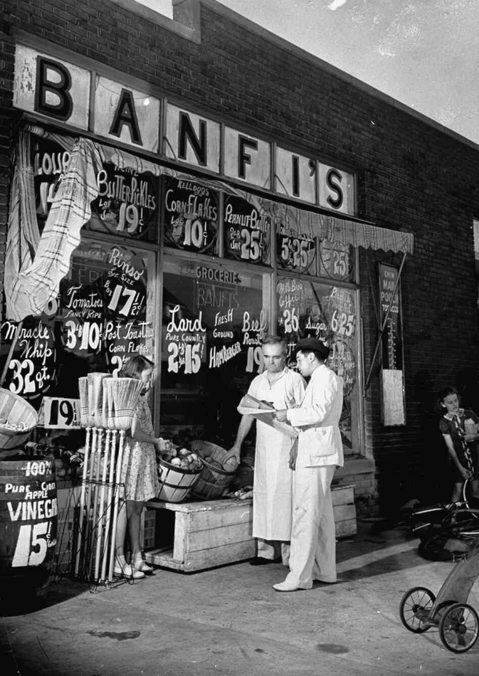 Where were you born? Grocery owner Oscar Banfi (center), who, along with his wife, was born in Hungary and had lived in South Bend for 27 years, talks with a "test census" taker, 1939. Where were you born? Grocery owner Oscar Banfi (center), who, along with his wife, was born in Hungary and had lived in South Bend for 27 years, talks with a "test census" taker, 1939.