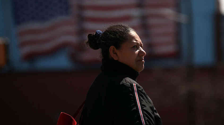  A Hispanic woman walks down a street in Union City, N.J. In a new study, the Pew Hispanic Center asked Hispanic-Americans how they identify themselves. 