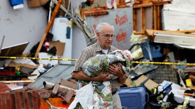 In Arlington, Texas, Tuesday afternoon, David Lowe carried his daughter's dog, Phoebe, away from the rubble. 