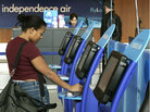 Lauren Goss of Knoxville, Tennessee, uses a self check-in machine to issue her boarding pass in front of an Independence Air ticketing counter at Dulles International Airport May 2, 2005 in Centreville, Virgina. In our second hour, Marketplace special correspondent David Brancaccio talks about his series, Robots Ate My Job, and how technology is becoming a bigger part of our lives. Lauren Goss of Knoxville, Tennessee, uses a self check-in machine to issue her boarding pass in front of an Independence Air ticketing counter at Dulles International Airport May 2, 2005 in Centreville, Virgina. In our second hour, Marketplace special correspondent David Brancaccio talks about his series, Robots Ate My Job, and how technology is becoming a bigger part of our lives.