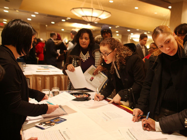 Job seekers attend a career fair in New York City. Federal Reserve Chairman Ben Bernanke says the quick drop in unemployment might have been a reversal of overzealous cutbacks during the financial crisis.