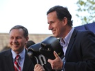 Rick Santorum speaks Wednesday in Hollidaysburg, Pa., holding boxing gloves given to him by Pennsylvania State Sen. John Eichelberger (left). On Thursday, Santorum met in private with a group of conservative leaders to discuss next steps in his campaign. Rick Santorum speaks Wednesday in Hollidaysburg, Pa., holding boxing gloves given to him by Pennsylvania State Sen. John Eichelberger (left). On Thursday, Santorum met in private with a group of conservative leaders to discuss next steps in his campaign.