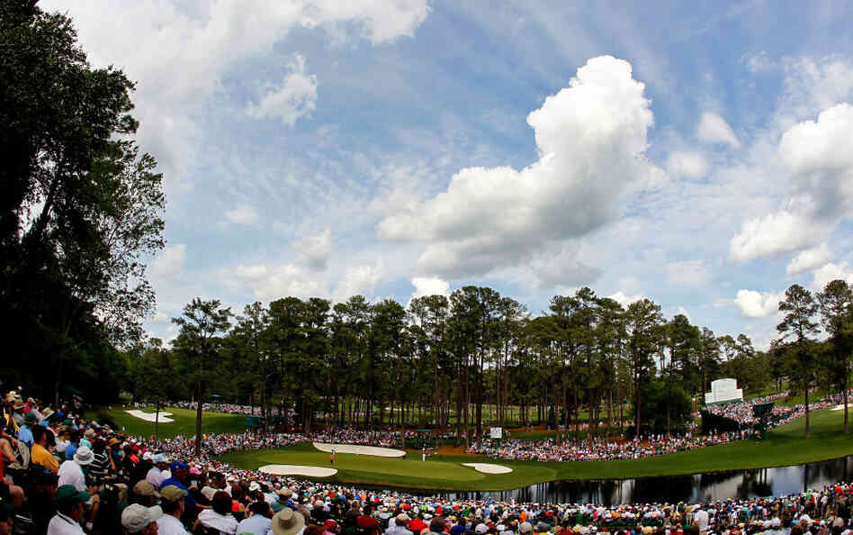 Patrons watch as Henrik Stenson of Sweden, Alvaro Quiros of Spain and Gary Woodland of the United States play the 16th green during the first round of the 2012 Masters Tournament at Augusta National Golf Club on Thursday.