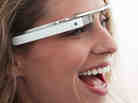 A woman wears a design version of Google's intended smart glasses from its Project Glass.