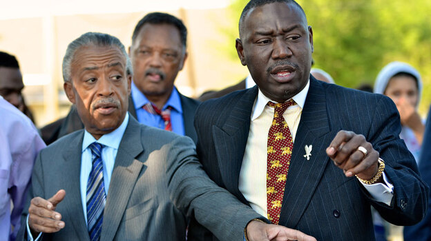 Benjamin Crump (right), the attorney for Trayvon Martin's family, is joined by the Revs. Al Sharpton and Jessie Jackson at a protest in Sanford, Fla., last week. Crump has enlisted the help of prominent civil rights activists to draw attention to the case. 