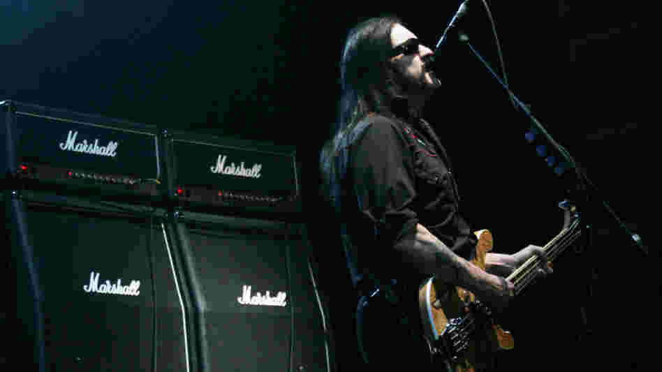 Lemmy Kilmister of Motorhead in front of a line of Marshall amps.