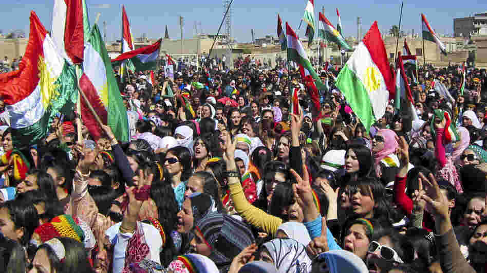 Kurds in Syria overwhelmingly oppose the current Syrian regime but have been hesitant to join in the fighting. Here, Kurds wave the Kurdish flag as they rally against the government in the northern city of Qamishli, Syria, on March 21. 