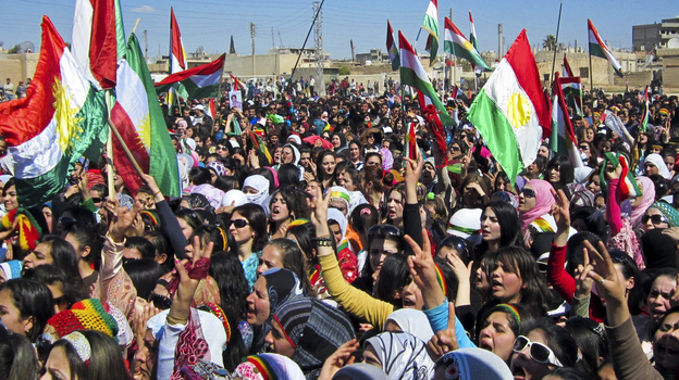Kurds in Syria overwhelmingly oppose the current Syrian regime but have been hesitant to join in the fighting. Here, Kurds wave the Kurdish flag as they rally against the government in the northern city of Qamishli, Syria, on March 21. Kurds in Syria overwhelmingly oppose the current Syrian regime but have been hesitant to join in the fighting. Here, Kurds wave the Kurdish flag as they rally against the government in the northern city of Qamishli, Syria, on March 21.
