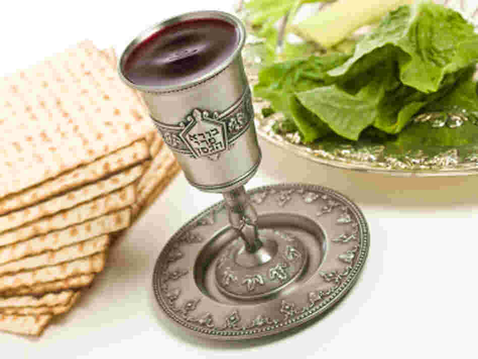 A kiddush cup, Seder plate and matzo for Passover. Words from the traditional Hebrew blessing of the wine are written on the cup. A kiddush cup, Seder plate and matzo for Passover. Words from the traditional Hebrew blessing of the wine are written on the cup.